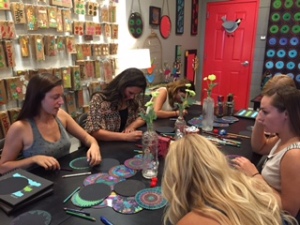 Girls busily coloring out the darkness during workshop.